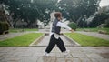 Woman hip hop dancer performing energetic movements in city park. Girl dancing Royalty Free Stock Photo