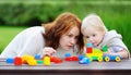 Woman with his son playing with colorful plastic blocks Royalty Free Stock Photo