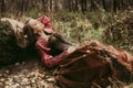 Woman in historical dress resting in autumn forest. Royalty Free Stock Photo