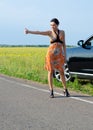 Woman hitchhiking after a breakdown Royalty Free Stock Photo