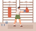 Woman hitting boxing punching bag with hand in gloves. Female fighter training in gym. Strength exercises, workout and