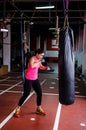 Woman hitting the punching bag Royalty Free Stock Photo