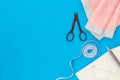 Woman hobby. Set for tailor shop with thread, scissors, fabric on blue background top view copy space Royalty Free Stock Photo