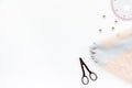 Woman hobby. Set for tailor shop with thread, scissors, fabric on white background top view copy space Royalty Free Stock Photo