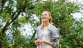 Woman hold apple garden background. Farm produce organic natural product. Girl rustic style gather harvest garden autumn Royalty Free Stock Photo