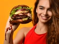 Woman hold big burger sandwich in hand hungry mouth getting ready to eat Royalty Free Stock Photo