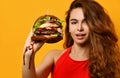 Woman hold big burger sandwich in hand hungry mouth getting ready to eat Royalty Free Stock Photo