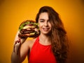 Woman hold big burger sandwich in hand hungry mouth getting ready to eat Royalty Free Stock Photo