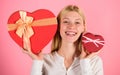 Woman hold big and little heart shaped gift boxes. Which one she prefer. Girl decide which gift she like more. Big