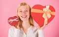 Woman hold big and little heart shaped gift boxes. Which one she prefer. Girl decide which gift she like more. Big Royalty Free Stock Photo