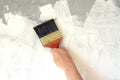 Woman hold brush and painting wall repair