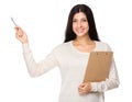 Woman hold with clipboard and pen point up Royalty Free Stock Photo