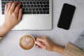 Woman hold coffee cup while working on her laptop. happy morning concept. flat lay