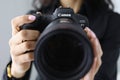 Woman hold new model canon EOS R5 camera in hand closeup