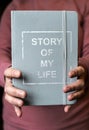 Woman hold notebook. Book notes for the Story of my life. Personal memoirs notes concept Royalty Free Stock Photo