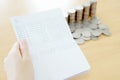 Woman hold passbook on hand, coins