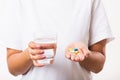 Woman hold pill drugs in hand ready take medicines with a glass of water