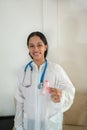 Woman hold pink ribbon for breast cancer awareness. Blurred background. Copy space available Royalty Free Stock Photo