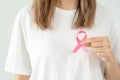 Woman hold pink ribbon breast cancer awareness. Female health check consciousness. international Women Day and World Cancer Day. Royalty Free Stock Photo