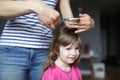 Woman hold scissors and lock of hair for child. Royalty Free Stock Photo