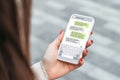 Woman holdind smartphone and texting outdoors. chatting with a phone Royalty Free Stock Photo