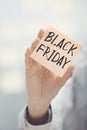 Woman holding adhesive note Black Friday text Royalty Free Stock Photo