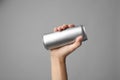 Woman holding aluminum can with beverage on grey, closeup. Space for design Royalty Free Stock Photo