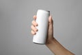 Woman holding aluminum can with beverage on grey, closeup. Space for design Royalty Free Stock Photo