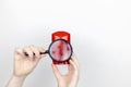 A woman is holding antiperspirant, examines the composition under a magnifying glass. Place for your text. The concept of