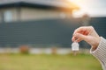 Woman holding apartment keys in front of house Royalty Free Stock Photo
