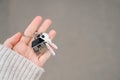 Woman holding apartment keys in front of house Royalty Free Stock Photo