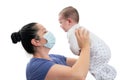 Woman holding baby daughter while wearing disposable medical mask Royalty Free Stock Photo