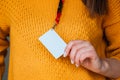 Woman holding badge name tag, with blank space mock up