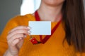 Woman holding badge name tag, with blank space mock up