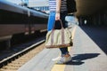 Woman holding a bag at a railway station
