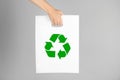 Woman holding bag with recycling symbol on grey background, closeup Royalty Free Stock Photo