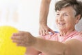 Woman holding ball in physiotherapy