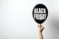 Woman holding balloon with phrase BLACK FRIDAY on white background, space for text Royalty Free Stock Photo