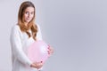 Woman Holding a Balloon to her Belly