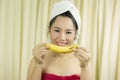 Woman holding banana acting smile, sad, funny, wear a skirt to cover her breast after wash hair, Wrapped in Towels After Shower