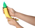 Woman holding banana in condom on white background, closeup. Safe sex concept Royalty Free Stock Photo