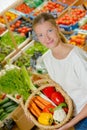 Woman holding basket filled with vegetables Royalty Free Stock Photo