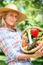 Woman holding basket of vegetables. Royalty Free Stock Photo