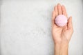 Woman holding bath bomb over foam, top view Royalty Free Stock Photo