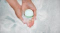 Woman holding bath bomb over water with foam, top view. Space for text Royalty Free Stock Photo