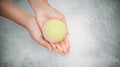 Woman holding bath bomb over water with foam, top view. Space for text Royalty Free Stock Photo