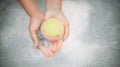 Woman holding bath bomb over water with foam, top view. Space for text Royalty Free Stock Photo
