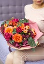 Woman holding a beautiful bouquet of large roses and different flowers Royalty Free Stock Photo