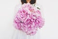 Woman holding beautiful bunch of fresh pink peony flowers in full bloom. Royalty Free Stock Photo