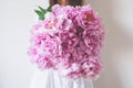 Woman holding beautiful bunch of fresh pink peony flowers in full bloom Royalty Free Stock Photo